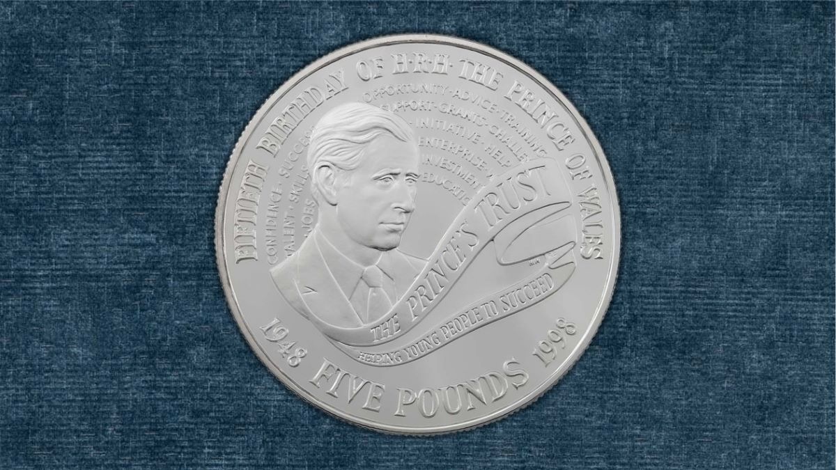 Reverse of a silver proof £5 Crown celebrating Prince Charles' 50t birthday and his work with the Princes Trust, issued in 1998.
